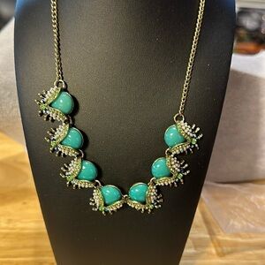 Plunder necklace. Adorable. Appears to be blue or aqua ladybugs with navy blue.‌